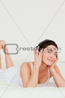 Portrait of a cute brunette listening to music