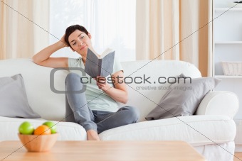Cute woman reading a book