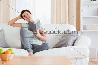 Cute brunette reading a book