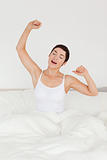 Portrait of a charming woman stretching her arms