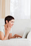 Portrait of a surpised woman using a laptop