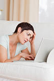 Tired young woman using a laptop