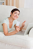 Portrait of a happy woman shopping online