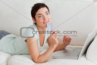 Pensive woman buying online