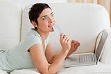 Pensive young woman buying online