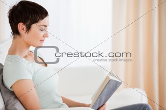 Short-haired woman reading a book