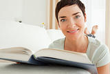 Close up of a short-haired woman with a book