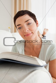 Portrait of a short-haired woman reading a book