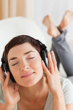 Portrait of a charming brunette listening to music