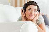 Close up of a short-haired brunette listening to music