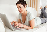 Gorgeous short-haired woman using a laptop