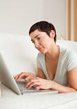Portrait of a gorgeous short-haired woman using a laptop