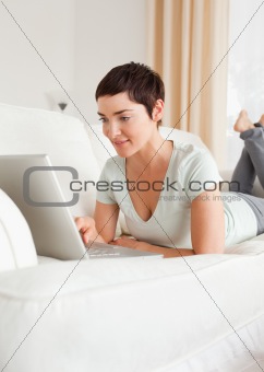 Portrait of a happy short-haired woman using a laptop