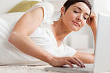 Close up of a quiet woman relaxing with a laptop