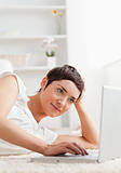 Portrait of a quiet woman relaxing with a laptop