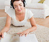 Woman reading a magazine while enjoying some music