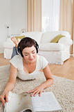 Portrait of a woman reading a magazine while enjoying some music