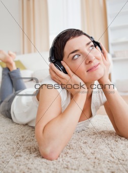Portrait of a dreaming woman listening to music