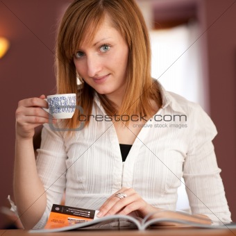 First capuccino - Beautiful young caucasian girl drinking coffee in a bar in early morning