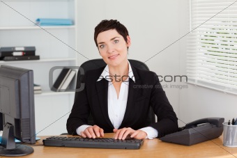 Young secretary typing on her keybord