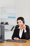 Portrait of a secretary calling with a headset