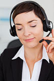 Portrait of a smiling secretary calling with a headset