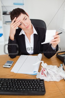 Portrait of a serious accountant checking receipts