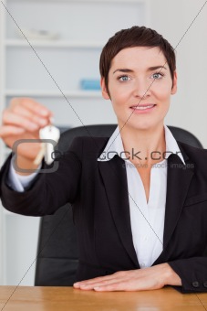 Portrait of a smiling secretary showing keys