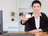Businesswoman showing a blank business card