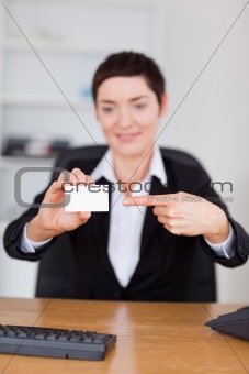 Portrait of a secrertary showing a blank business card