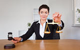 Young woman with a gavel and the justice scale