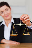 Serious woman holding the justice scale