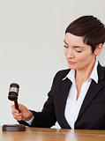 Portrait of a woman knocking a gavel