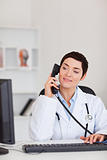 Portrait of a female doctor making a phone call