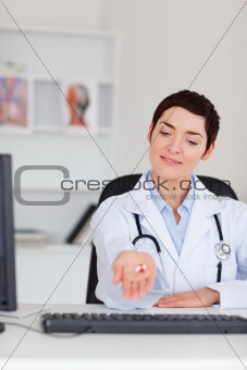Doctor showing pills