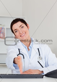 Female doctor giving her hand