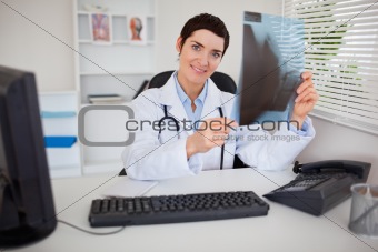 Smiling female doctor holding a set of X-ray