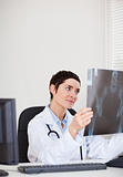 Focused female doctor looking at X-ray