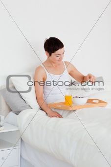 Portrait of a young woman having breakfast