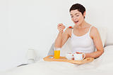 Cute woman eating cereal