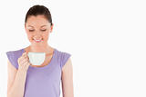Lovely woman enjoying a cup of coffee while standing