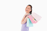 Beautiful woman holding shopping bags while standing