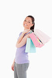 Good looking woman holding shopping bags while standing