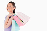 Attractive woman holding shopping bags while standing