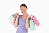 Pretty woman holding shopping bags while standing
