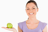 Attractive woman holding an apple while standing
