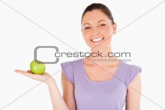 Beautiful woman holding an apple while standing