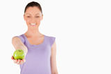 Pretty woman holding an apple while standing