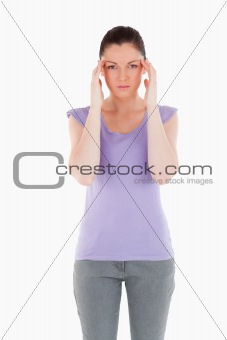 Lovely woman having a headache while standing