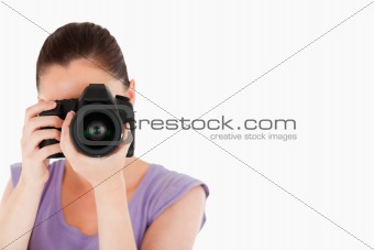 Beautiful female using a camera while standing